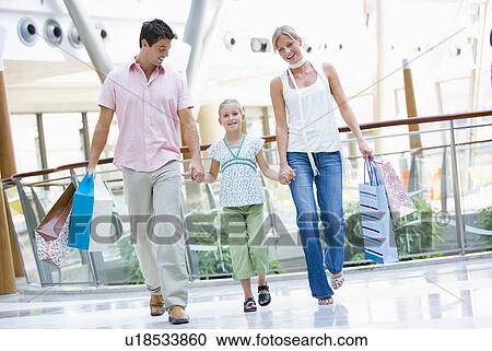 Mother and father with young daughter at a shopping mall View Large Photo Image Stock Image - Mother and father with young daughter at a shopping mall. Fotosearch