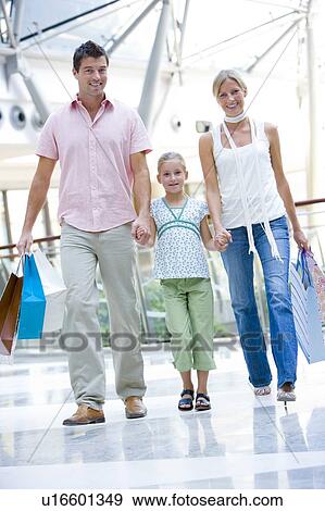 Stock Photo - Mother and father with young daughter at a shopping mall. Fotosearch