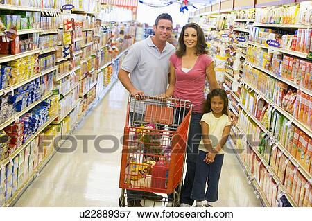 Mother and father with young daughter shopping at the grocery store. View Large Photo Image Stock Photo - Mother and father with young daughter shopping at the grocery store.. Fotosearch