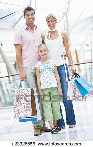 Stock Photograph - Mother and father with young daughter at a shopping mall. Fotosearch