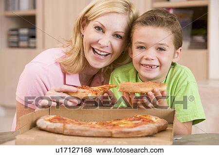 Stock Photo - Mother And Son Eating Pizza Together. Fotosearch