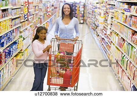 Mother and young daughter shopping at a grocery store View Large Photo Image Stock Photo - Mother and young daughter shopping at a grocery store. Fotosearch