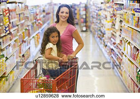 Mother and young daughter shopping at a grocery store. View Large Photo Image Stock Photo - Mother and young daughter shopping at a grocery store.. Fotosearch
