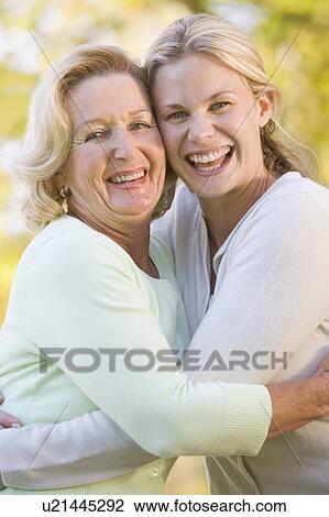Mother hugging grown up daughter View Large Photo Image Stock Image - Mother hugging grown up daughter. Fotosearch