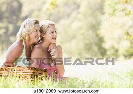 Mother with adult daughter on picnic View Large Photo Image Stock Photo - Mother with adult daughter on picnic. Fotosearch