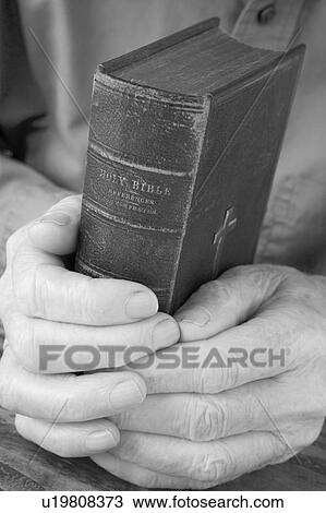 Stock Image - Older Man Holding Bible. Fotosearch