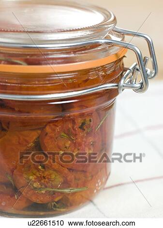 Stock Image - Oven Dried Tomatoes in a Jar. Fotosearch