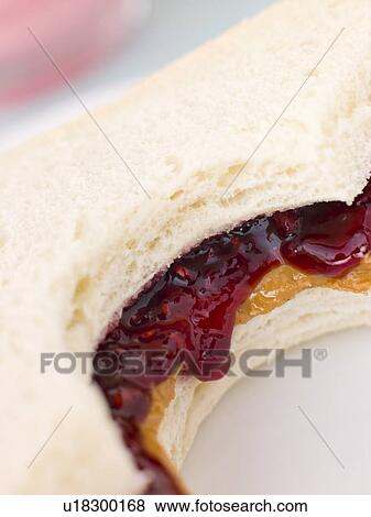 Stock Photo - Peanut Butter And Raspberry Jelly Sandwich On White Bread. Fotosearch