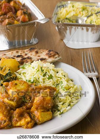 Stock Photo - Plate Of Indian Take Away- Chicken Bhoona, Sag Aloo, Pilau Rice And Naan Bread. Fotosearch