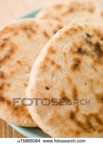 Picture - Plate of Plain Naan Breads. Fotosearch