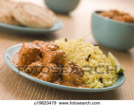 Stock Photo - Plated Chicken Korma with Pilau Rice and Naan bread. Fotosearch