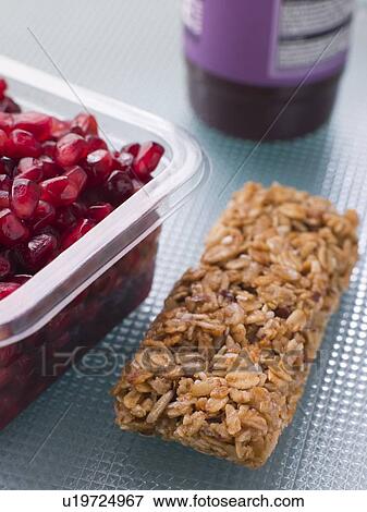 Stock Photo - Pomegranate Seeds With A Cereal Bar And Berry Smoothie. Fotosearch