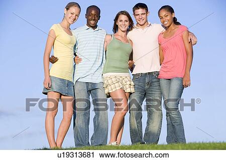 Stock Image - Portrait Of A Group Of Teenagers Outdoors . Fotosearch