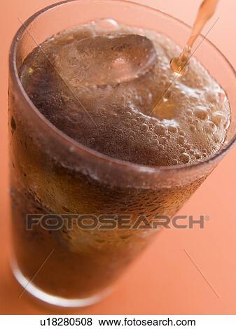 Pouring a Cola into a Glass with Ice Cubes View Large Photo Image Stock Photo - Pouring a Cola into a Glass with Ice Cubes. Fotosearch