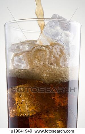 Stock Photo - Pouring Cola Into A Glass Of Ice. Fotosearch