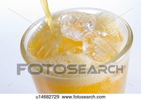 Pouring Orangeade Into A Glass Of Ice View Large Photo Image Stock Photo - Pouring Orangeade Into A Glass Of Ice. Fotosearch