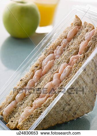 Stock Image - Prawn Marie Rose Sandwich On Granary Bread With An Apple And Orange Juice. Fotosearch