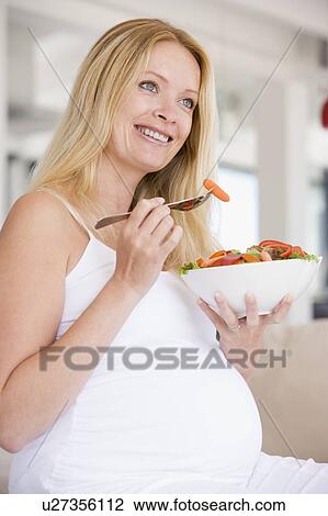 Pregnant woman with bowl of salad smiling View Large Photo Image Stock Image - Pregnant woman with bowl of salad smiling. Fotosearch