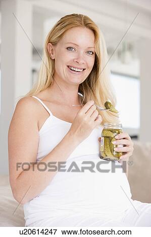 Pregnant woman with pickles smiling View Large Photo Image Stock Photo - Pregnant woman with pickles smiling. Fotosearch