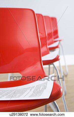 Stock Image - Row Of Chairs With Documents. Fotosearch