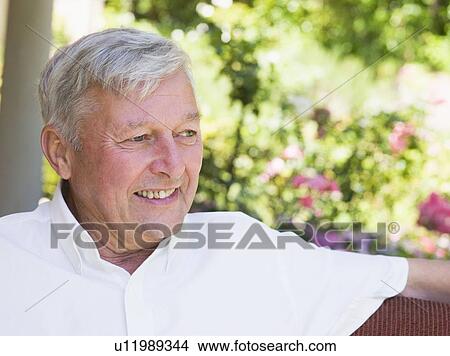 Picture - Senior man sitting outdoors. Fotosearch