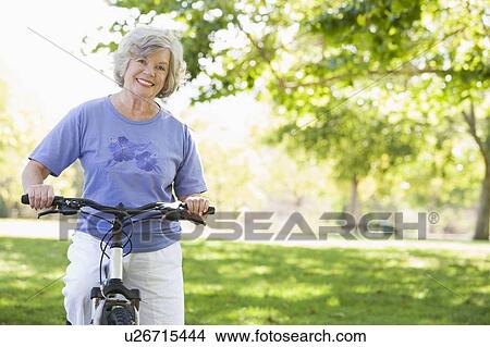 Senior woman on a bicycle View Large Photo Image Picture - Senior woman on a bicycle. Fotosearch