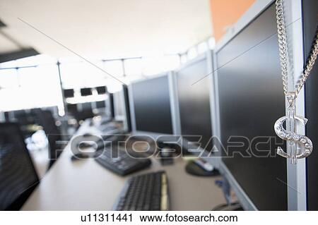 Stock Image - Shot of a necklace hanging on a monitor in a computer room. Fotosearch