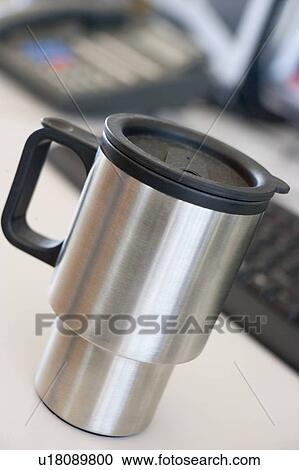 Shot of a reusable coffee cup on a desk View Large Photo Image Stock Image - Shot of a reusable coffee cup on a desk. Fotosearch