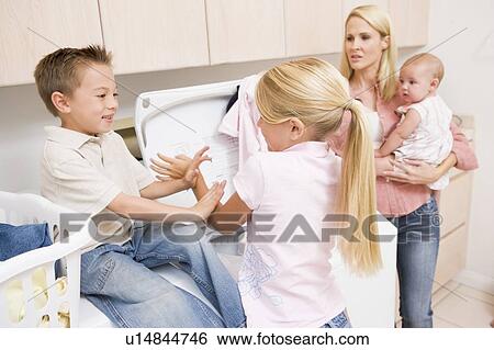 Stock Photograph - Siblings Fighting While Doing Laundry . Fotosearch