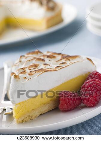Stock Image - Slice Of Lemon Meringue Pie With Raspberries. Fotosearch