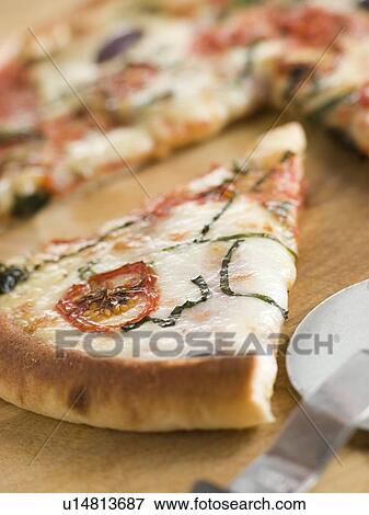 Slice of Tomato Mozzarella Aubergine and Basil Pizza View Large Photo Image Stock Photo - Slice of Tomato Mozzarella Aubergine and Basil Pizza. Fotosearch