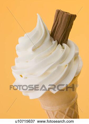 Stock Photo - Soft Whipped Ice Cream With A Chocolate Flake In A Wafer Cone. Fotosearch