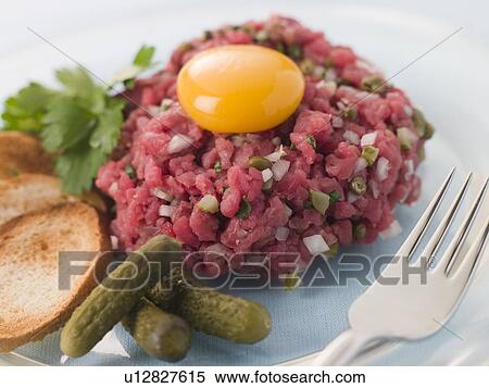 Steak Tartare with Cornichons, Croutons and an Egg Yolk View Large Photo Image Stock Photography - Steak Tartare with Cornichons, Croutons and an Egg Yolk. Fotosearch