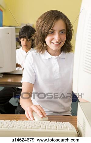 Student at computer terminal with student in background (selective focus) View Large Photo Image Stock Photo - Student at computer terminal with student in background (selective focus). Fotosearch