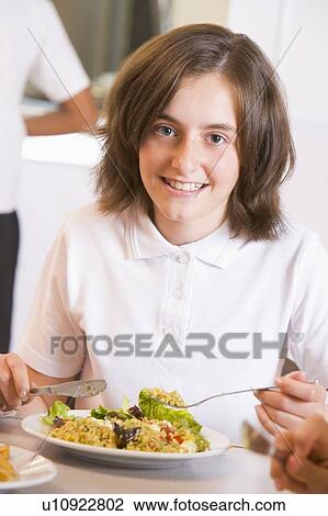 Student in cafeteria eating lunch (selective focus) View Large Photo Image Stock Image - Student in cafeteria eating lunch (selective focus). Fotosearch