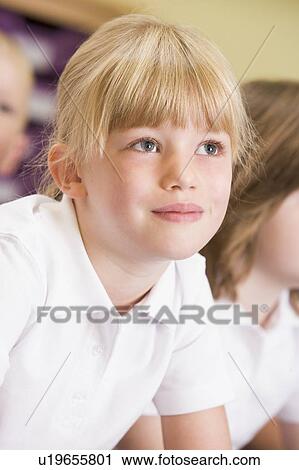 Stock Image - Student in class paying attention (selective focus). Fotosearch