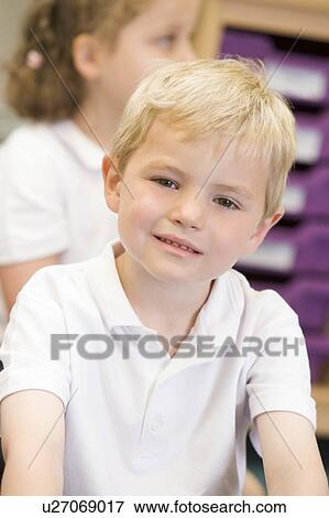 Stock Photo - Student in class sitting on floor (selective focus). Fotosearch