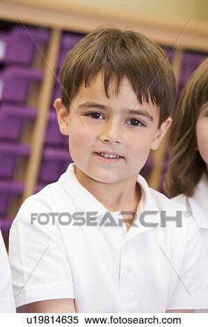 Stock Photography - Student in class sitting on floor (selective focus). Fotosearch