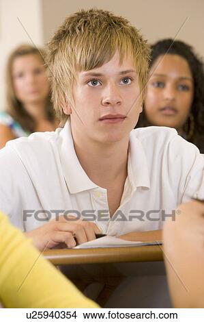Student in class taking notes (selective focus) View Large Photo Image Picture - Student in class taking notes (selective focus). Fotosearch