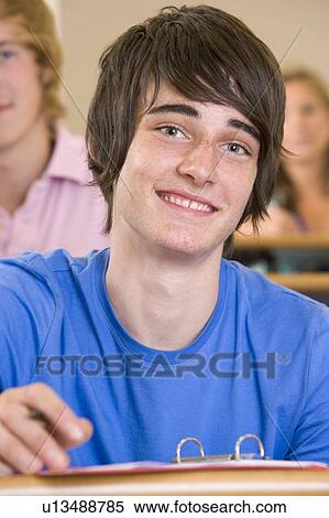 Stock Photography - Student in class taking notes (selective focus). Fotosearch