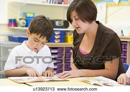 Student in class with teacher reading View Large Photo Image Stock Image - Student in class with teacher reading. Fotosearch