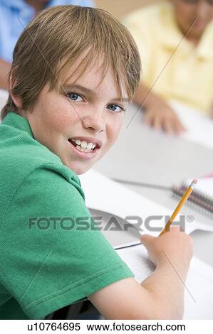 Student in class writing (selective focus) View Large Photo Image Stock Photography - Student in class writing (selective focus). Fotosearch