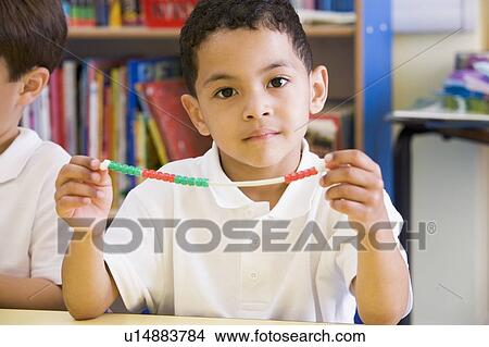 Student in math class with counting beads View Large Photo Image Picture - Student in math class with counting beads. Fotosearch