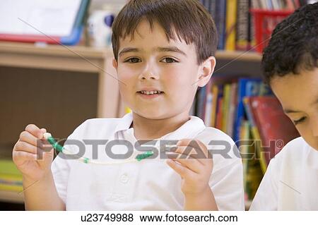 Student in math class with counting beads View Large Photo Image Stock Photo - Student in math class with counting beads. Fotosearch