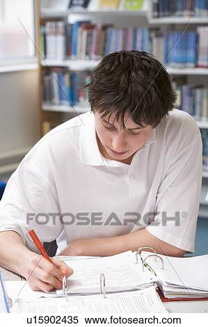 Stock Photography - Student writing and studying. Fotosearch