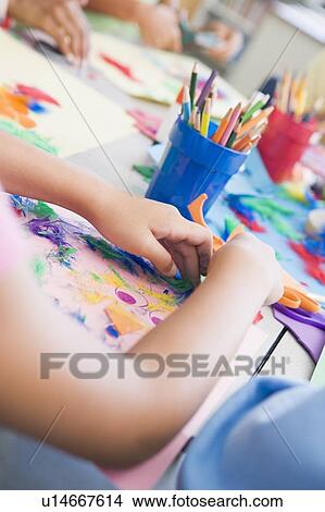 Picture - Students in art class focusing on hands (selective focus). Fotosearch