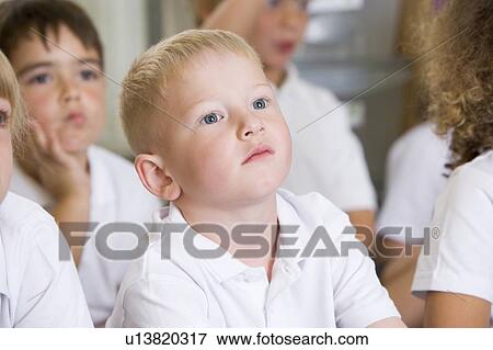 Stock Photo - Students in class sitting on floor bored (selective focus). Fotosearch