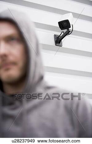 Surveillance Camera And Young Man In Hooded Sweatshirt View Large Photo Image Stock Photo - Surveillance Camera And Young Man In Hooded Sweatshirt. Fotosearch