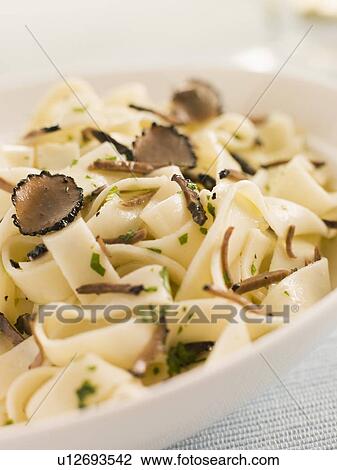 Stock Image - Tagaliatelli with Sliced Black Truffles. Fotosearch