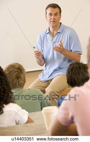 Teacher giving lecture to students in classroom (selective focus) View Large Photo Image Stock Image - Teacher giving lecture to students in classroom (selective focus). Fotosearch